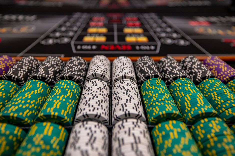 Close-up of colorful casino chips arranged on a gaming table, ready for play.